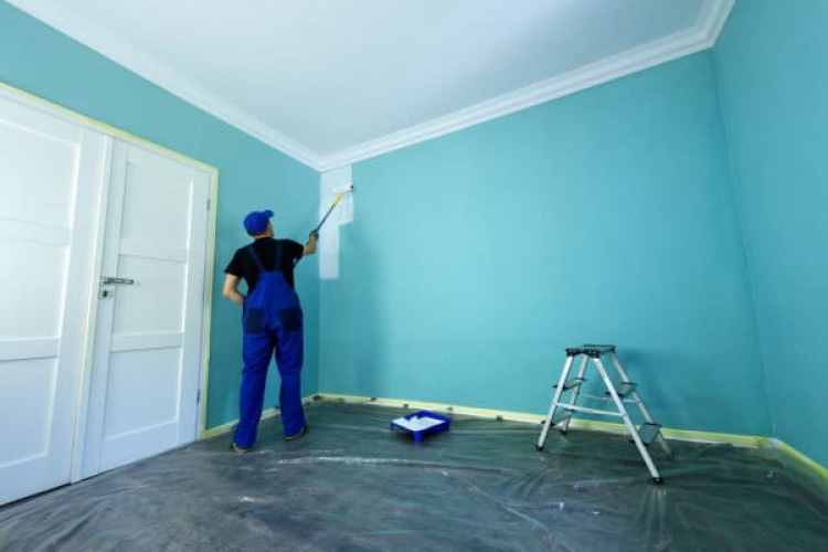 Worker painting wall